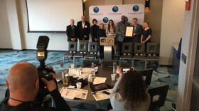 Local and state leaders in workforce and education pose with a "21st Century Talent Region" proclamation issued by Gov. Eric Holcomb.