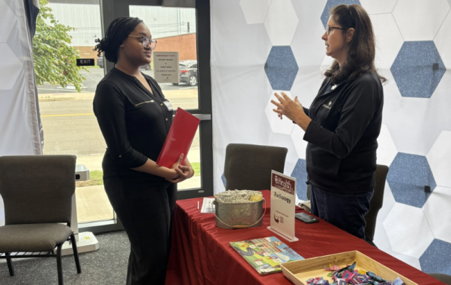 Nara Sykes speaks with a volunteer from OU Health at a celebration for students who participated in Future Forward. The new mentoring project guides students on their resumes, interviewing and workplace expectations.
