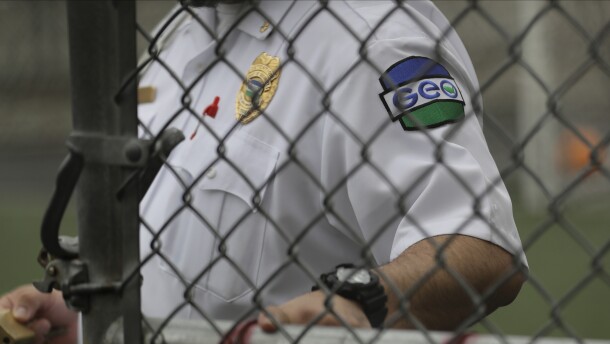 A GEO Group guard closes a door at a U.S. Immigration and Customs Enforcement detention center during a media tour on Dec. 16, 2019, in Tacoma, Washington.