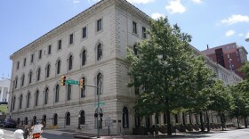 FILE - A pedestrian passes by the US 4th Circuit Court of Appeals Courthouse on Main Street in Richmond, Va., Wednesday, June 16, 2021. In a ruling Tuesday, April, April 16, 2024, a federal appeals court has overturned a West Virginia transgender sports ban, finding that the law violates Title IX, the federal civil rights law that prohibits sex-based discrimination in schools. (AP Photo/Steve Helber, File)