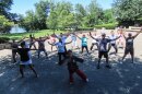 Movements flow like a river, a dance, as tai chi instructor Malee Khow leads a class at Great River Park in East Hartford, July 19.