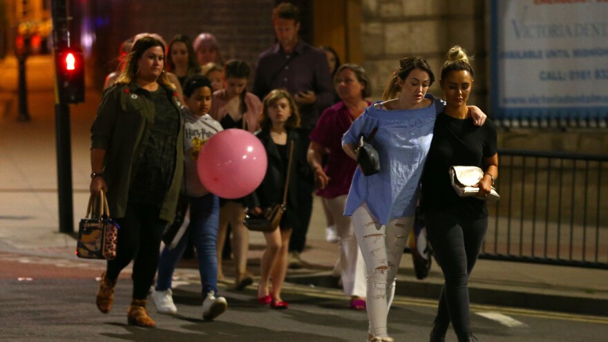 People leave Manchester Arena in England on Monday night following an explosion that killed at least 22 victims and wounded dozens more.