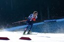 An action shot of a cross-country skier racing through the snow.