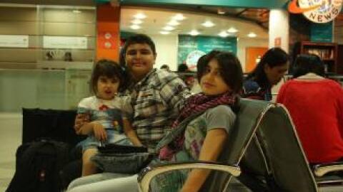 Photo: Mohammed, Mais and little Lamees wait in the airport in Amman to come to the U.S.