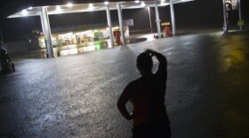 Convenience store employee Lindsey Bennight watched floodwaters surround the store where she works in Crawfordville, Fla., on Monday (June 25, 2012).