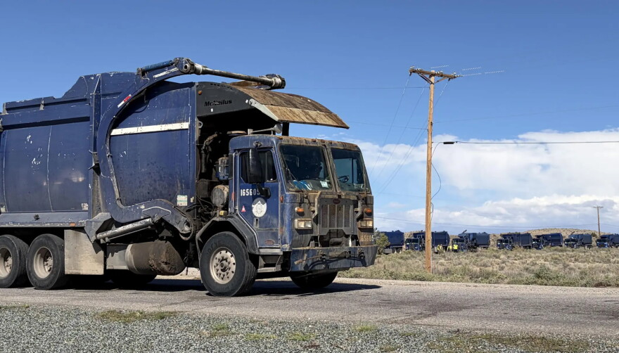 Garbage trucks wait in line to dump trash at the Cerro Colorado Landfill Wednesday afternoon after heavy rain forced the site to close Tuesday.