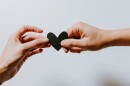 Two people holding a papercut heart