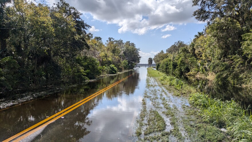 A flooded road seemingly disappears into Lake Jesup in Seminole County on October 23, 2024, two weeks after Hurricane Milton hit Florida as a deadly Category 3 storm.