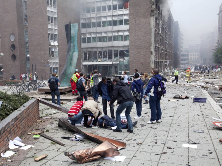 Injured people lay on the ground at the site of an explosion near the government buildings in Norway's capital Oslo earlier today (July 22, 2011).