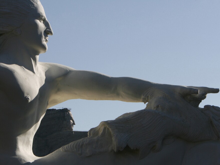 A 1/34th scale model of what the Crazy Horse sculpture will look like, foreground, frames the actual carving in 2006.