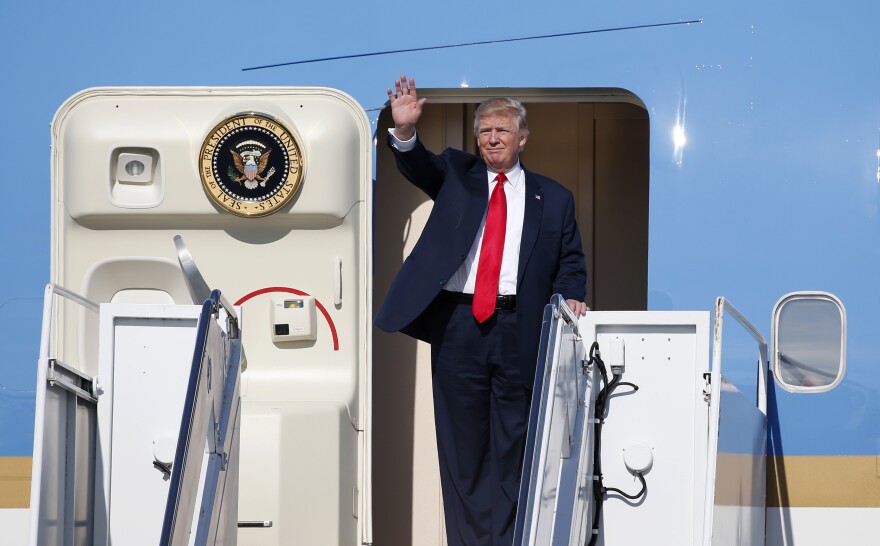 President Trump steps off Air Force One as he arrives in West Palm Beach, Fla., on Friday. The president is holding a rally in the state on Saturday.