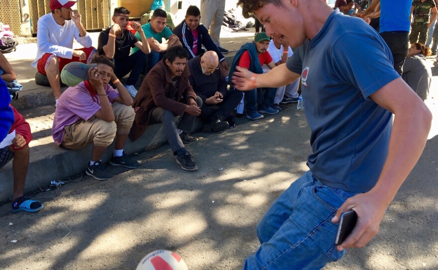 Street soccer - and watching it - passes the long days of waiting for migrants.