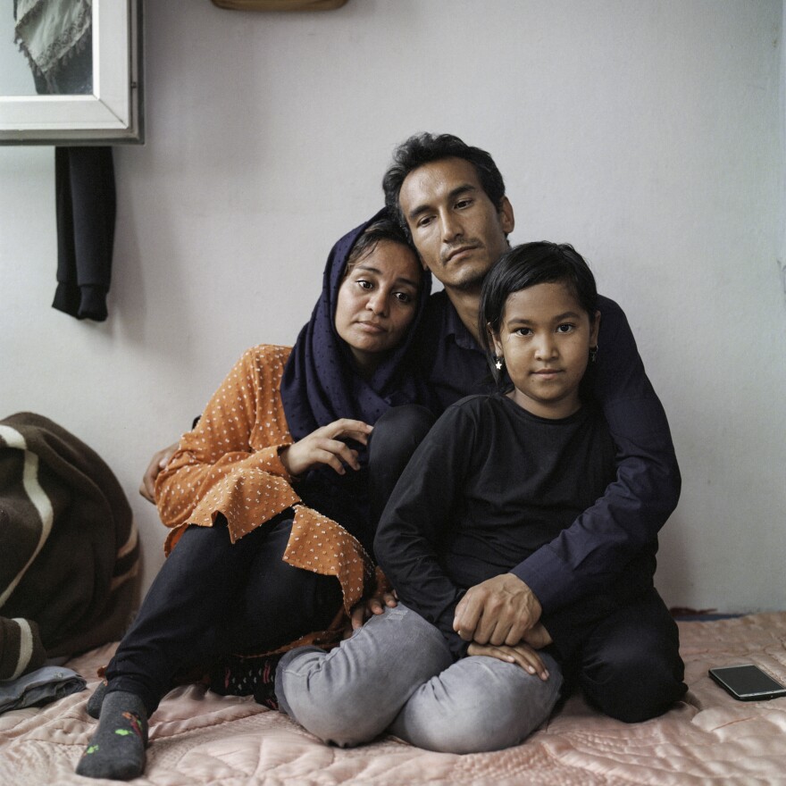 Sayyid Ali Hussaini (center), his wife Mahbube and daughter Elisa sit together in the Turkish city of Trabzon. Originally from the northern Afghan city of Mazar-e-Sharif, the family fled Taliban advances over the summer and arrived in Turkey last month.