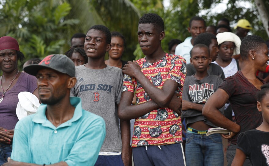 Families wait to receive humanitarian aid from a U.S. Army helicopter unit in the town of Anse-A-Veau, Haiti, on Wednesday.