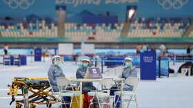 Medical staff in personal protective equipment look on during a training session at National Speed Skating Oval on Jan. 28, 2022 in Beijing, China.  (Lintao Zhang/Getty Images)
