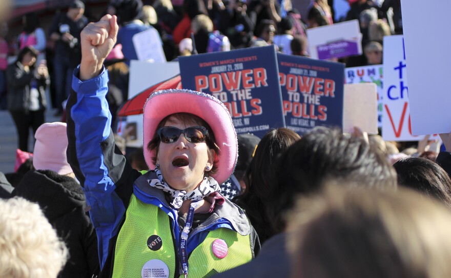 Diane Askwyth leads cheers as protesters make their way to Sam Boyd Stadium for the Women's March "Power to the Polls" voter registration tour launch on Sunday, in Las Vegas, Nev.