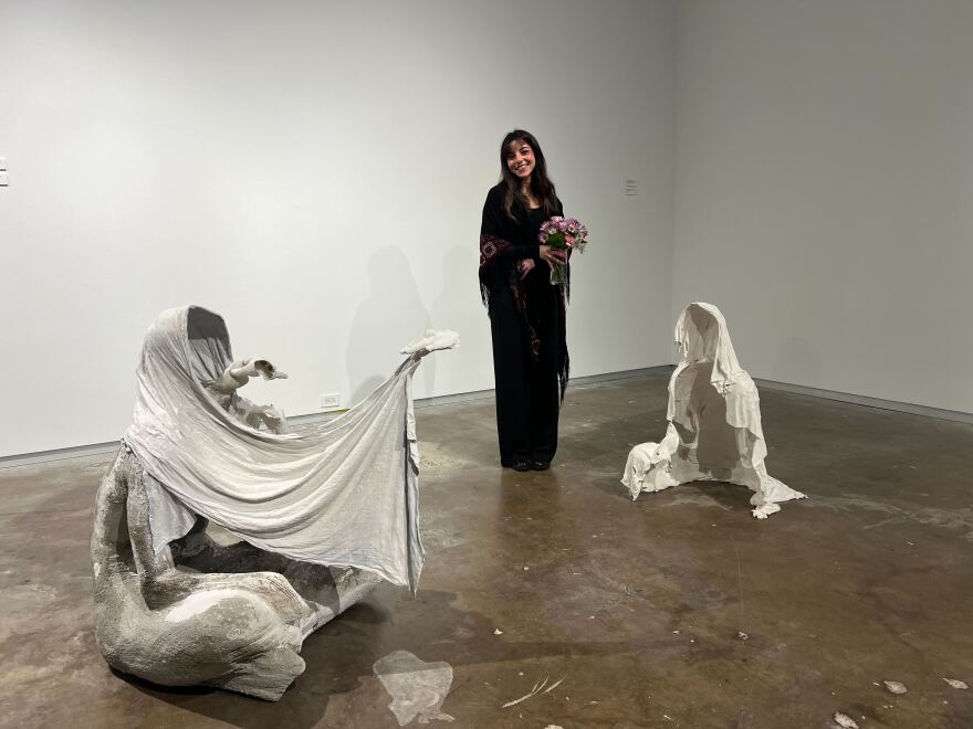 Nadin Nassar, a graduate student at the University of North Texas, standing in front of "Sometimes I wish that you could really see but it's safer if we just pretend" at Dallas Contemporary on February 13, 2026.
