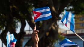Women wave Cuban flags during a rally calling for the end of the U.S. blockade against the island nation in Havana, Cuba, Tuesday, April 7, 2026.