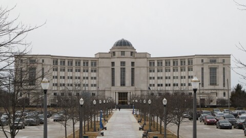 In a photo from Jan. 17, 2020, the Michigan Hall of Justice is seen in Lansing, Mich. It's a large grey concrete building with a parking lot out front.