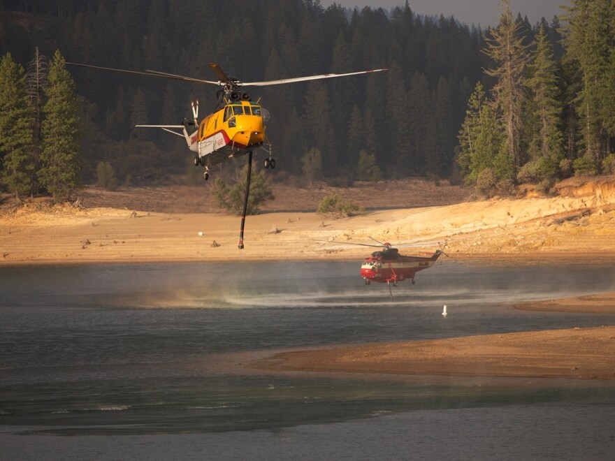 Helicopters draw water from Jenkinson Lake to drop on the Caldor Fire Monday, Aug. 23, 2021.