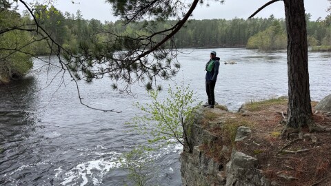 Eric Newell standing near river rapids