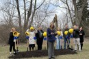 A woman stands in front of Stoneleigh Residence employees before they break ground on the new expansion. 