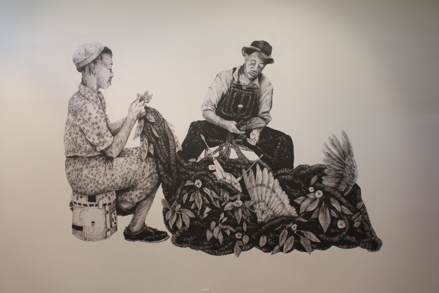One of three wheat paste murals by Antoine Williams on display at the Greenville Museum of Art.