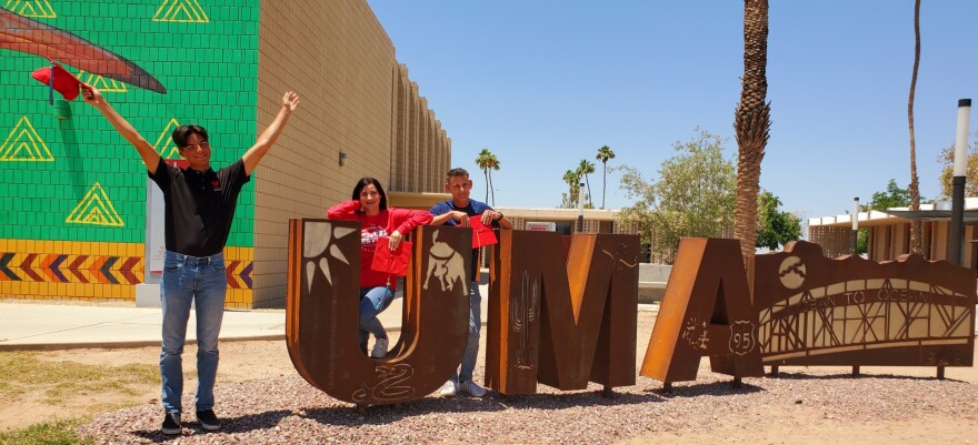 Jakkson, Christine and Eric Reese will graduate from Arizona Western College together. These UMA letters are on the Yuma Main Campus.