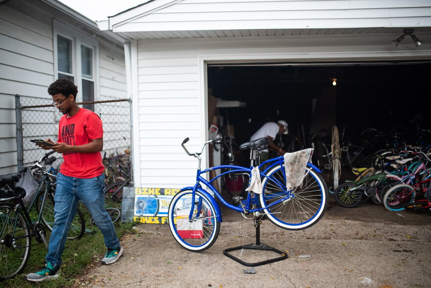 Samson Terefe takes notes on an iPad of parts needed for the The Biker Boyz &a Girlz Shop in Indianapolis. (Lucas Carter for Here & Now)