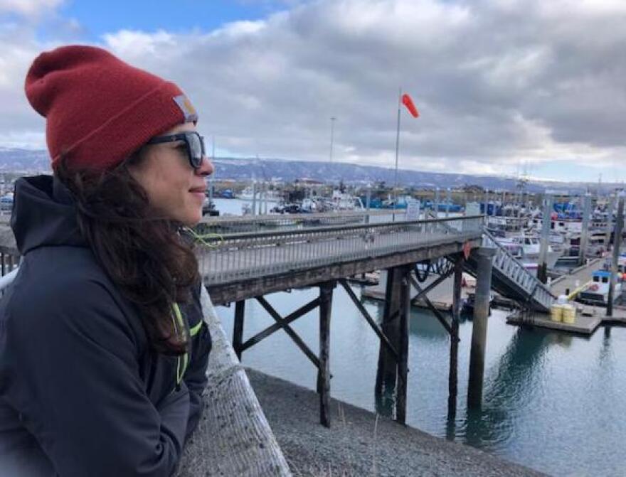 Alex Ravelo, a former NOAA Fisheries observer, looks out onto Homer’s docks. (Photo by Renee Gross/KBBI)
