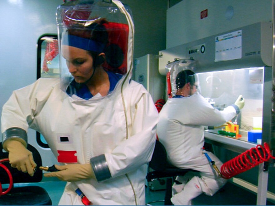 Two scientists are suited up for work inside the Biosafety Level 4 lab in Montana.