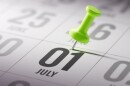desk calendar with a tack going through july 1 