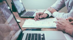 image of people working, people handling paperwork, and using laptops.