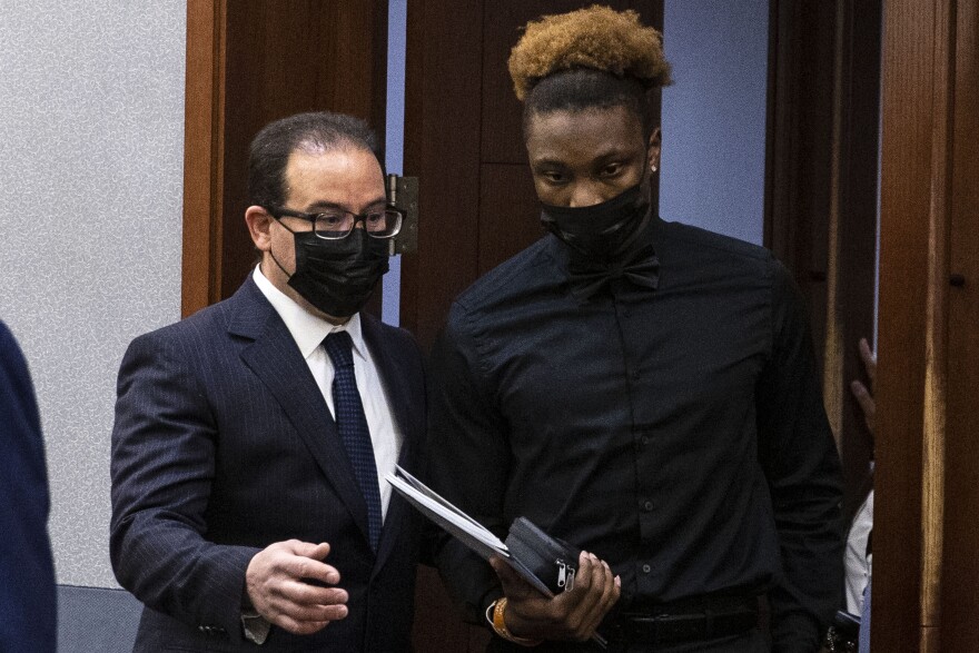 Henry Ruggs, right, former Raiders wide receiver, accused of DUI resulting in death, enters the courtroom with his attorney Richard Schonfeld, at the Regional Justice Center, Monday, Nov. 22, 2021, in Las Vegas. (Bizuayehu Tesfaye/Las Vegas Review-Journal via AP, Pool)