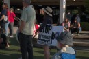 A rally-goer holds a sign saying, "Stop ICE terror now!" in Springfield on Aug. 8, 2026.