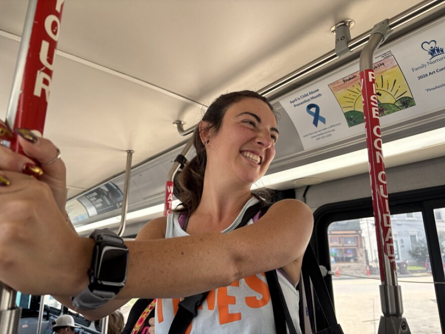 PONES dancer Lori Kaufman passes out mini shakers and stickers for Ride with an Artist Day.