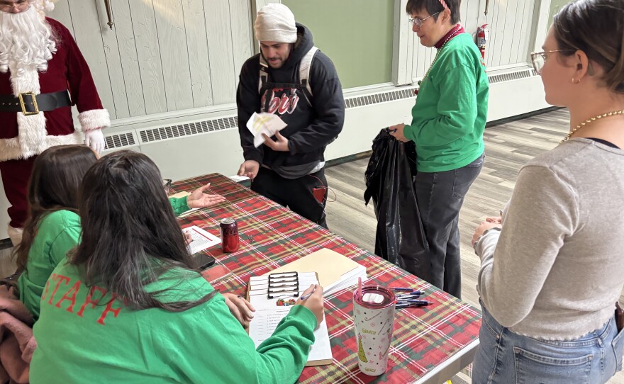 Justin Paduani checks in at the Gifts for Kids giveaway in Carbondale.