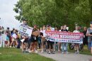 Pro-immigrant protesters line up to march in Fishers on Saturday, Aug. 1, 2026.