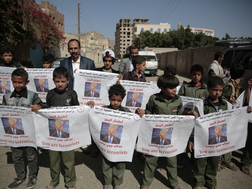 Boys hold posters with crossed-out pictures of President Trump during an April march against plans by the Arab coalition to attack Hodeidah, Yemen.