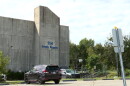 A concrete building and parking not