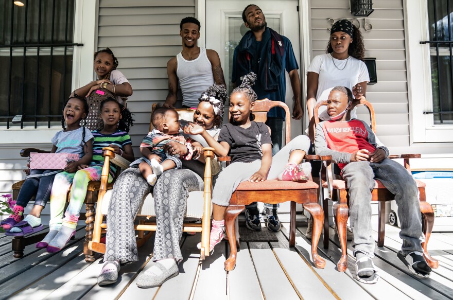 Tasharn Richardson and her family gather on the new porch. She says her kids — especially her teenage daughter — have been her strictest financial advisers.