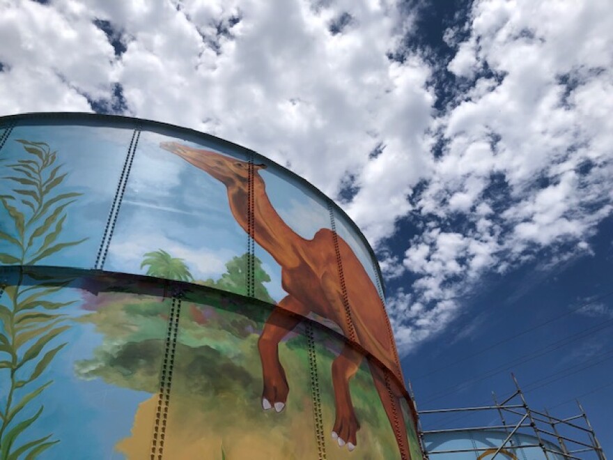 Artist MB Hanrahan's gigantic Jurassic mural is taking shape on two water tanks off of Highway 33 in West Ventura.