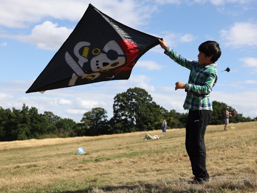 Children fly kites at Parliament Hill viewpoint on Saturday in London to mark one year since the fall of Afghanistan to the Taliban.