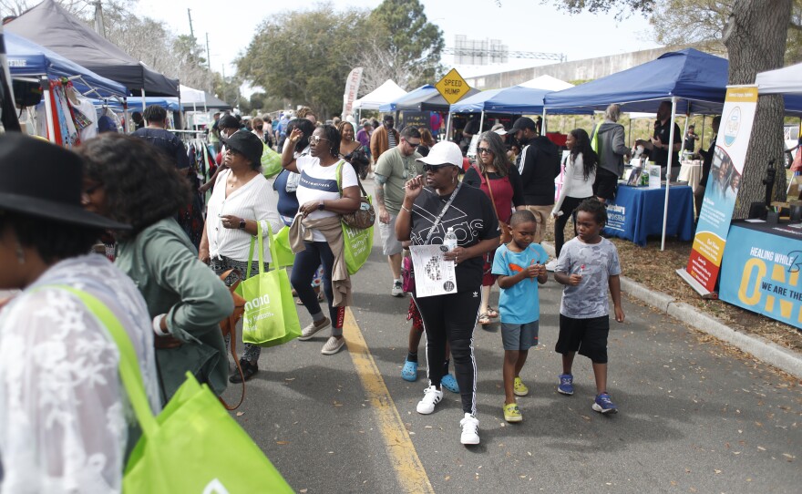 Festival are seen walking during the 2022 Publix Tampa Bay Collard Festival in St. Petersburg, Florida, on Saturday, February 19, 2022. Photo by Octavio Jones for WUSF