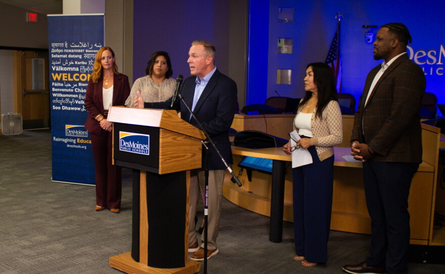Members of the Des Moines School Board congratulate interim superintendent Matt Smith, who they just named permanent superintendent.