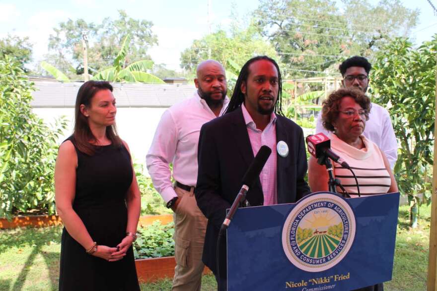 Eric Range, board chair of Minorities for Medical Marijuana speaks during a press conference at Infinite Zion farm in Parramore, flanked by Agriculture Commissioner Nikki Fried and State Rep Geraldine Thompson, while Infinite Zion founder Ray Warthen looks on. Photo: Matthew Peddie, WMFE News