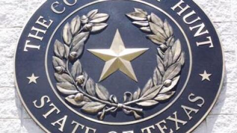 The seal of Hunt County hangs from the county courthouse wall.