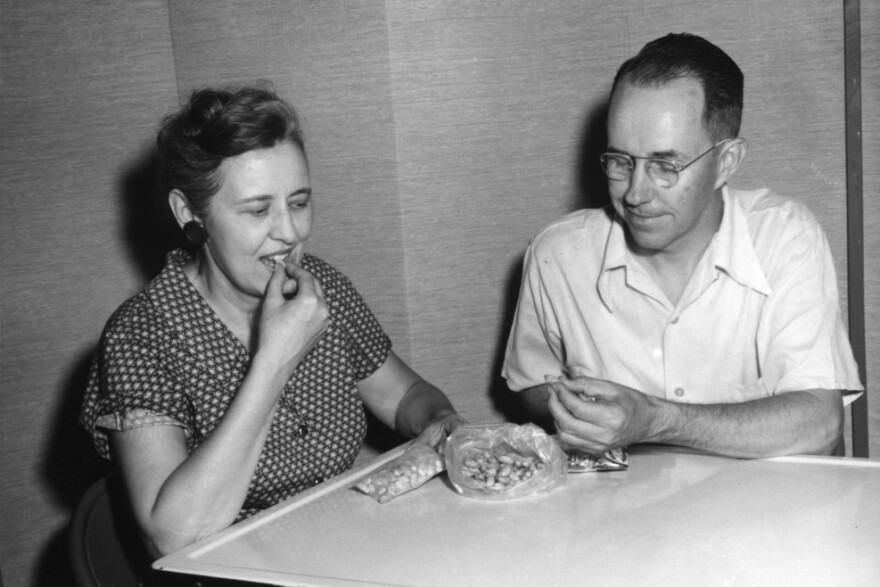 Man and woman eating "atomic" peanuts, 1959.