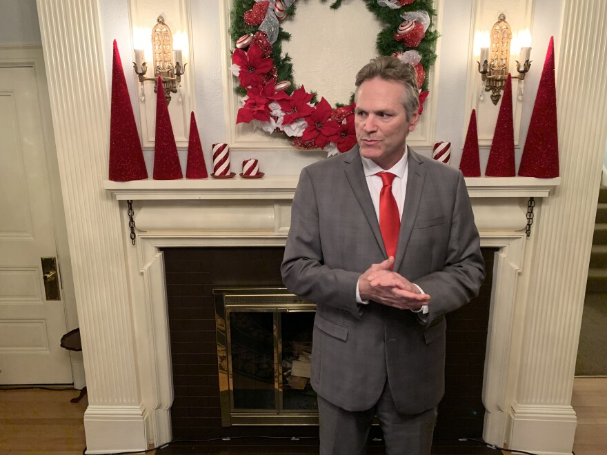Gov. Mike Dunleavy waits for guests at the annual Christmas open house on Tuesday, December 10, 2019 in Juneau, Alaska. (Photo by Rashah McChesney/KTOO)