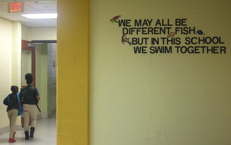 A sign in the hallway at Crocker College Prep. Here, students are no longer automatically punished for disruptive behavior. A new approach aims to catch and understand kids whose behavior may be a response to trauma.